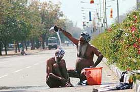 Protesting farmers beat the heat at the road separating Sectors 16 and 17 in Chandigarh on Monday
