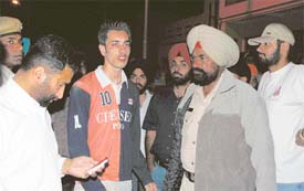 Police officials with a youth whose parents were murdered at BRS Nagar, Ludhiana, on Sunday night