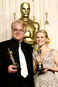 Best actor Philip Seymour Hoffman and best actress Reese Witherspoon pose with their Oscars at the 78th annual Academy Awards in Hollywood on Sunday