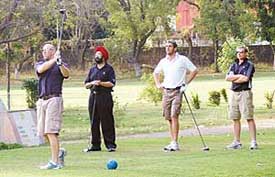 Englands Plunkett watches his tee shot at the ninth hole at the Chandigarh Golf Club on Tuesday. Also seen in the picture are Ian Bell and Matt Prior. 