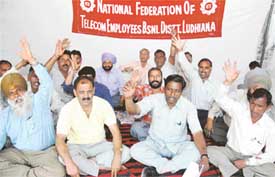Activists of the National Federation of Telecom Employees and the BSNL staff stage a dharna in front of the telecom office in Ludhiana
