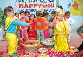 Students of Kiddies Paradise play Holi with flower petals at the school in Ludhiana on Friday