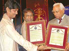 Haryana Governor A. R. Kidwai (right) confers Koser awards on Charna Girdhar Chand (left) and Shahid Parvez at the Tagore Theatre in Chandigarh on Saturday.