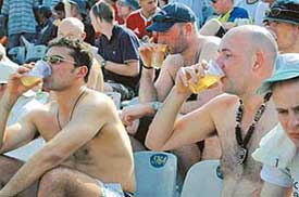 English cricket fans enjoy drinks during the match