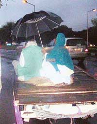 A couple huddles under an umbrella during rain in Chandigarh on Saturday. 
