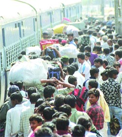Migrants leaving for their native places to celebrate Holi at New Delhi Railway Station