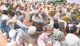 People wait for their turn at an eye camp held at the Civil Hospital, Mandi Ahmedgarh, on Sunday