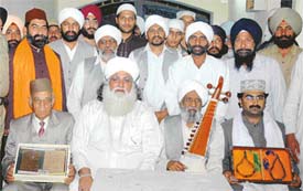 Members of a Pakistani delegation pose with the items gifted by Sikh Gurus, in Ludhiana on Sunday