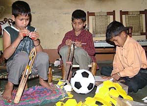 Children stitching footballs at Basti Danishmandan in Jalandhar.