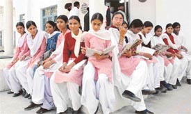 Students of Class X take one last look at their books before entering the examination hall