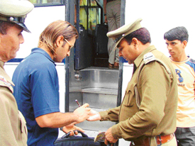 A police personnel takes autograph of cricket star Mahendra Singh Dhoni in Chandigarh on Tuesday. 