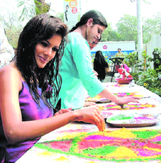 Model Amanpreet Wahi participates in a rangoli-making competition on the eve of Holi in the Capital on Tuesday.