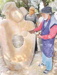 An artist gives the finishing touches to his sculpture at Kalagram