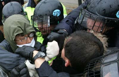 South Korean farmers and activists scuffle with riot policemen during a rally against the expansion of a US base at their village in Pyongtaek, about 80 km south of Seoul, on Thursday