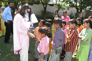 Ms Kiran Choudhary, Minister of State for Tourism, Haryana, interacts with less-privileged children after inaugurating an exhibition of their paintings at the Mango Grove School in Panchkula, on Saturday.