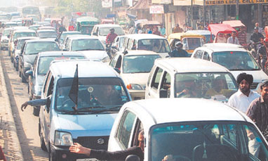 Traders on a slow motor car rally in various parts of Delhi protesting against the sealing of shops in the Capital on Friday.