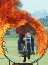 An Army officer jumps through a ring of fire at a show in Chennai on Thursday