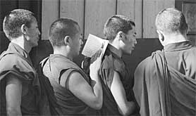 Tibetan monks stand in a queue for polling for the Tibetan Parliament in Dharamsala on Saturday.