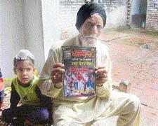 Jagjit Singh, 86-year-old father of Paramjit Singh Bheora, shows articles written by his son at Bheora village in Ropar district on Monday. 