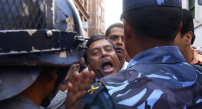 A pro-democracy activist argues with the riot police during a sit-in protest demanding the countrys return to democracy and the release of all detained leaders at Bhotahity near the Royal Palace in Kathmandu on Monday