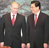 Visiting Russian President Vladimir Putin jokes with Chinese President Hu Jintao at a pact-signing ceremony at the Great Hall of the People in Beijing on Tuesday