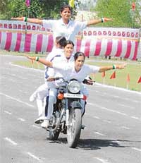Four policewomen present an intrepid act on a motor cycle at the Punjab Police Academy, Phillaur, on Tuesday