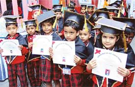 Students of Springdale Kindergarten School, Ludhiana, show their pass certificates on Tuesday
