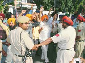 Policemen stop Opposition councillors from entering the Circuit House in Ludhiana on Tuesday