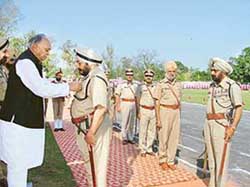 DGP Punjab S.S. Virk being presented with Presidents Police Medal for distinguished service by Finance Minister Surinder Singla at the Punjab Police Academy, Phillaur, on Tuesday. Other awardess are seen in the background. 