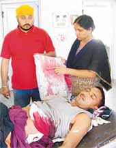 Victim Mehar Singh along with his wife Vimal Kaur at the hospital.