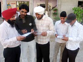Boys discuss Home Science paper outside a Punjab Board examination centre at Ahmedgarh