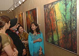 Noted sculptor Shiv Singh, along with college staff and students, during the exhibition. 
