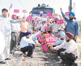 Poultry farmers hold protest on the railway track in Dhandari Kalan in Ludhiana on Thursday