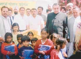 Mr Harnam Dass Johar, Education Minister, Punjab, after distributing uniforms among poor students of a primary school in Ludhiana on Thursday