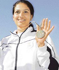 Anuja Jung, wife of Samresh Jung, shows her gold medal after winning the womens 50m rifle competion at the Commonwealth Games in Melbourne on Thursday