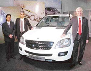 Dr Wildfried Aubur, Managing Director and CEO, Diamler Chrysler India, Mr Suhas Kadlaskar, Director for Corporate Affairs, and Mr Sanjiv Sahajwala, Director of Sales and Marketing, pose with company's latest edition of the Mercedes Benz M-class in Chennai
