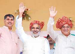 Union Rural Development Minister Raghuvansh Prasad Singh (centre) and Haryana Chief Minister Bhupinder Singh Hooda at Panchayati Raj sammelan at Rai near Sonepat on Sunday.