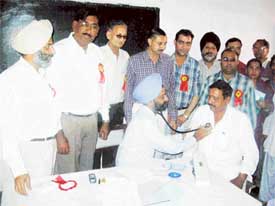 Patients being examined at a free heart check-up camp organised by the Rotary Club at Ahmedgarh