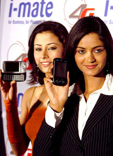 Models launch i-mate JAMin mobile phone, a new hi-tech PC based on Windows mobile 5.0, at a press conference in New Delhi on Wednesday