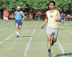 Athletes take part in the 400 m race at the fourth Inter-district FCI athletics meet in Chandigarh on Wednesday