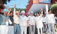 Employees of the CTU protest in front of the police station at Industrial Area, Phase I, Chandigarh, on Wednesday