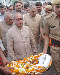 Defence Minister Pranab Mukerjee, senior Congress leader Moti Lal Vora and Haryana Chief Minister Bhupinder Singh Hooda arrive to pay their last respects to former Chief Minister Bansi Lal at his residence in Bhiwani on Wednesday.