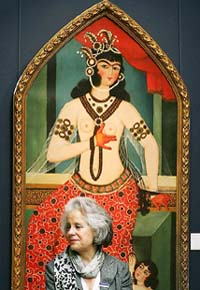 A Sothebys employee stands in front of a painting, A mother and child, attributable to Muhammad Hasan (1810-1830) during a photocall at the auction house in London