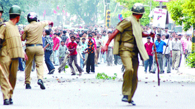 Irate shopowners and their employees pelt stones on a police force requisioned for the MCD drive to seal unauthorised shops in the Capital on Friday