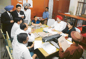 Consumer Forum President A.S. Narula and member of the forum Pooja Dewan hear cases during a Lok Adalat in Ludhiana on Friday