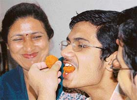 Abhishek Dhawan, topper in the Class VIII examination, celebrates with his mother in Chandigarh