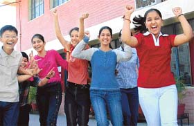 Damini of Manav Mangal High School, Sector 21, who stood second in the Class VIII examination in Chandigarh by securing 95.6 per cent marks, celebrates with her classmates at the school
