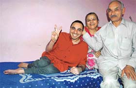 Ganesh celebrates his success in the examination with parents Pushpa and B. D. Sharma