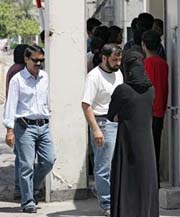 Bahraini and Indian relatives wait outside Manamas Intelligence Centre for news on the handover of the bodies of relatives who died two days earlier in a boat accident in Gulf waters off the coast of the Bahraini capital