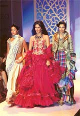 Models along with actress Katrina Kaif display creations by Ritu Beri at the grand finale of the Lakme Fashion Week in Mumbai on Saturday night